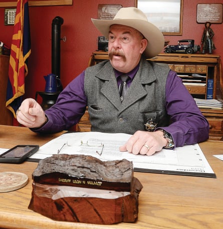 Yuma county sheriff Leon Wilmot sits behind his desk. 