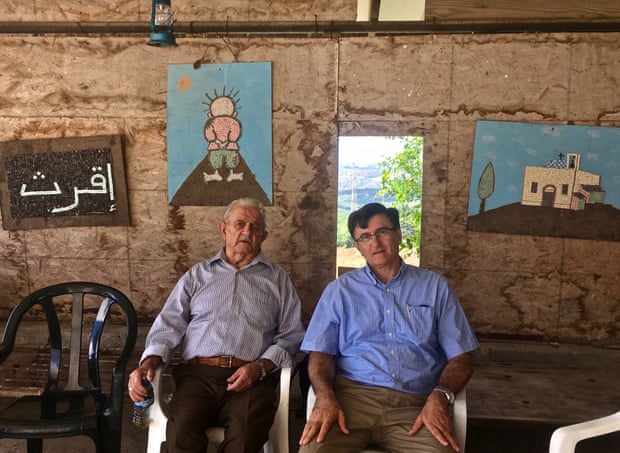 Ashkar winery owner Nemi Ashkar and his father, Maarof, 91 - who are both Christians - relax after monthly church prayers in Iqrit.