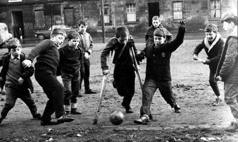 Boys play football in a Glasgow street in 1967.
