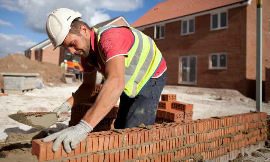 A man laying bricks