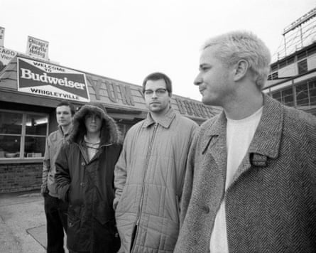 A monochrome photo of the four outside a diner. They are wearing winter clothes