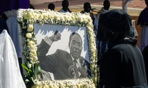 Former first lady Grace Mugabe walks past a portrait of Robert Mugabe during the burial of the former Zimbabwe leader at his home village in Kutama