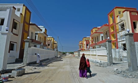 People walk through Daru Salaam city, a new housing estate in northern Mogadishu.