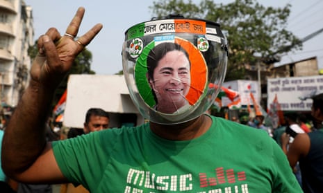 A supporter of Mamata Banerjee, who won a third term as chief minister of West Bengal, celebrates in Kolkata on Sunday.