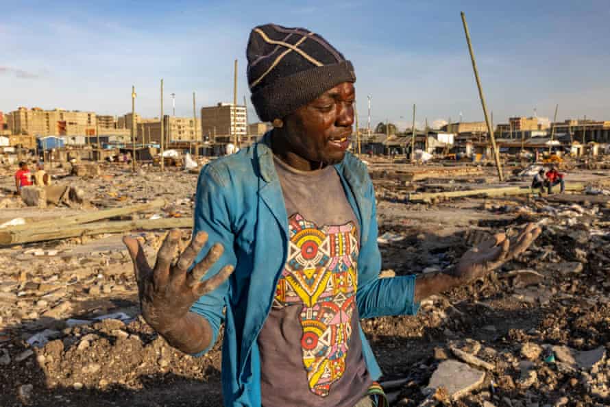 Emanuel Sikuku, 25, despairs in front of the site of his home that was destroyed to make way for the toll road, Mukuru Kwa Njenga
