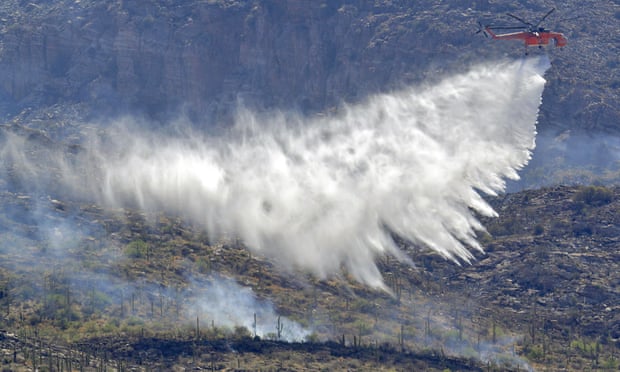 A wildfire air attack crew battles the Bighorn fire along the western side of the Santa Catalina Mountains on 12 June.