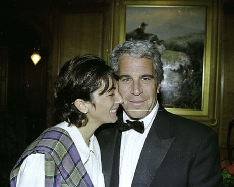 woman in white shirt and man in tuxedo smile together