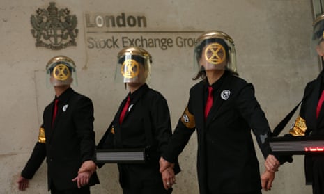 Extinction Rebellion protesters who have glued themselves to the entrances of the London Stock Exchange in the City of London.