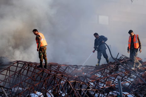 Emergency services work at a destroyed building hit by an air strike in Damascus, Syria.