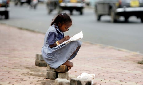 In this 2007 image, Nusrat, a girl belonging to a homeless family, studies school books at pavement in Mumbai