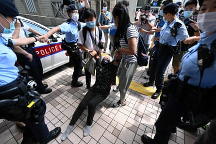 Well known pro-democracy protester Grandma Wong is dragged away by police inside the court grounds in Hong Kong on Saturday.