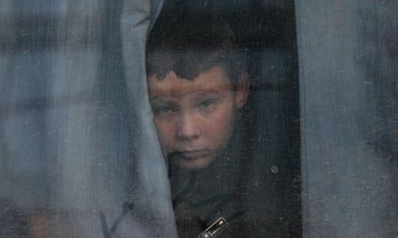 Russian troops loot Kherson as traces redrawn forward of ultimate battle for metropolis | Ukraine 1 A boy looks out from a bus window as civilians are evacuated from Kherson