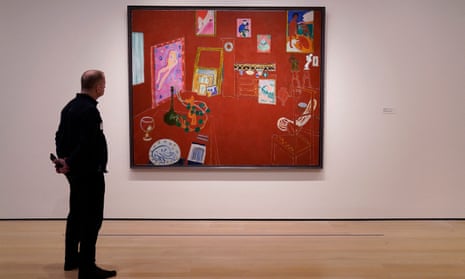 ‘It’s not like works are born famous. It may be a few years, many decades, or centuries before it lands on the wall where viewers look at it’ … a person looks at Henri Matisse's The Red Studio