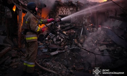 A firefighter works at the site of a residential house hit by a Russian drone strike in Mykolaiv, Ukraine, 17 November 2024.