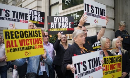 A demonstration with placards including ‘Recognise all victims, hashtag Contaminated blood