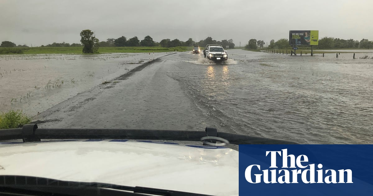 Travellers stranded and emergency refuges opened as heavy rain cuts off roads in north Queensland