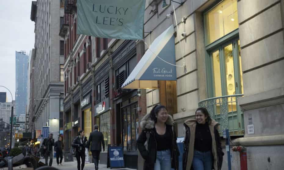 Pedestrians walk past the Lucky Lee’s restaurant in Greenwich Village, New York City.