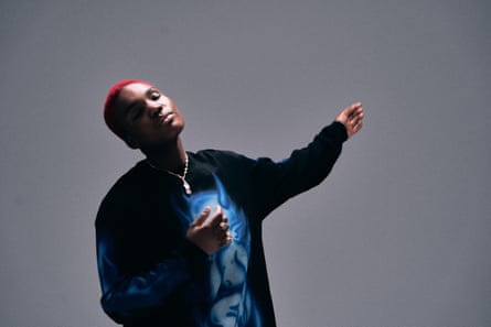 A woman with red hair and a black long-sleeved top swaying.