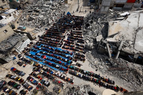 Palestinians perform Friday prayers near the ruins of a mosque destroyed by Israeli strikes in Rafah.