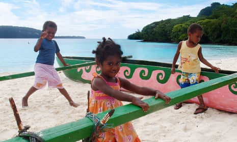 Children play on Champagne beach, Espiritu Santo, Vanuatu.