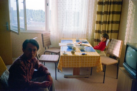 A photograph of two children inside an apartment