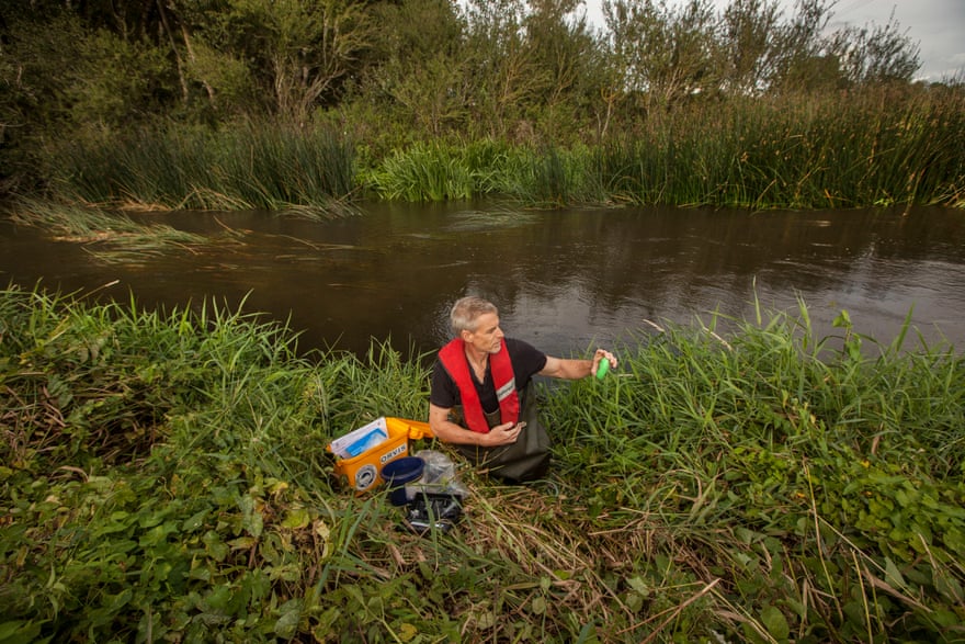 Swallowfield Angling Club member Ross Hatchett emerges from the water with an analysis kit.