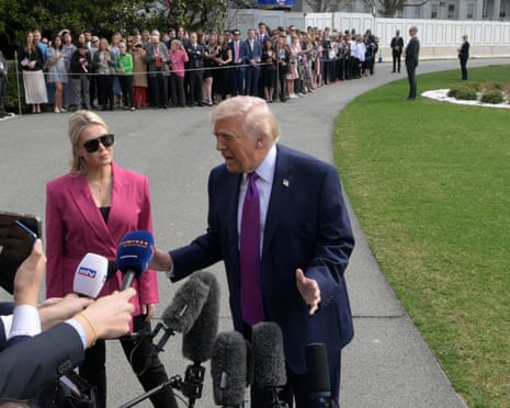Donald Trump talks with reporters before departing Washington DC for Hebron, Kentucky.