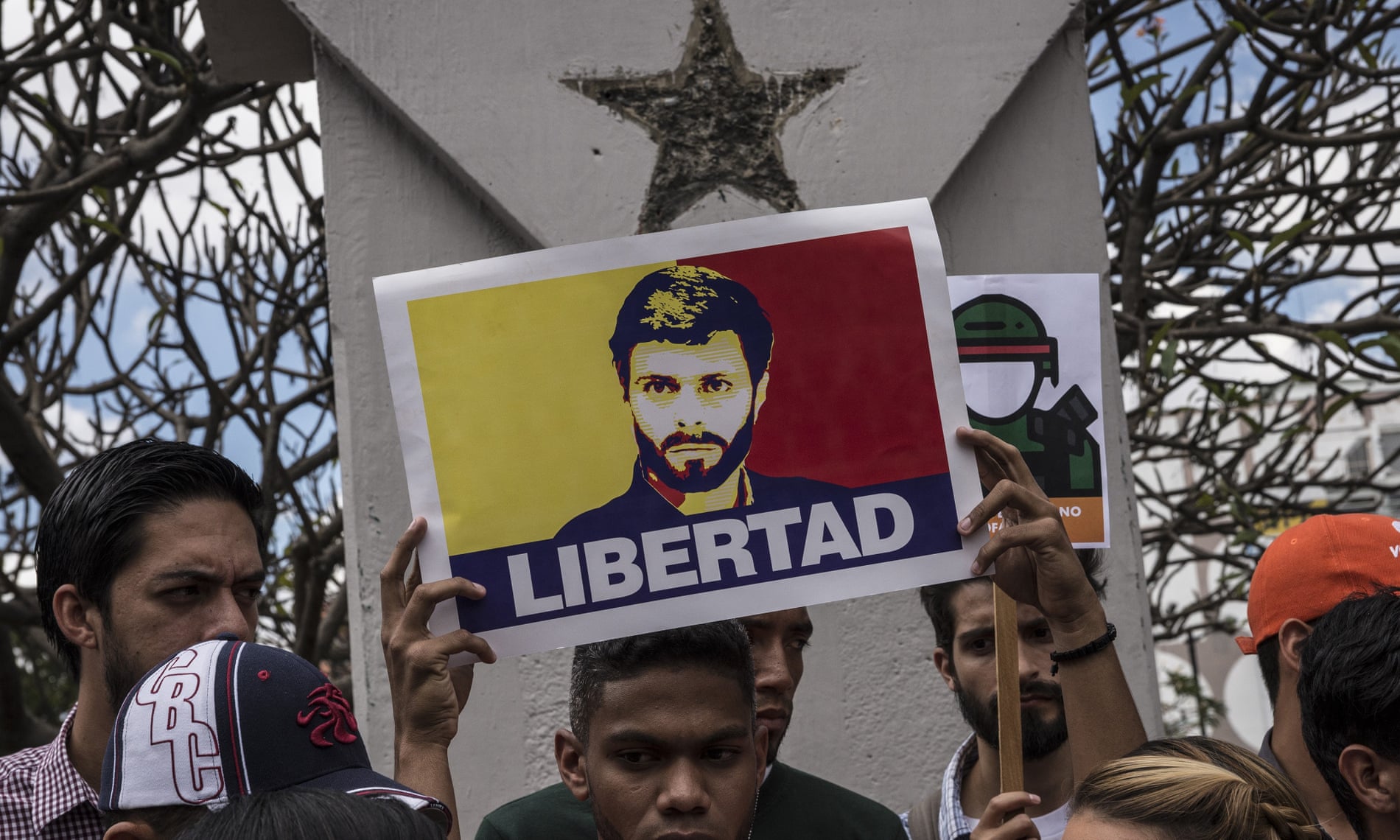 A man holds a poster of the opposition leader Leopoldo López, who is under house arrest, during a protest in Caracas on 30 January 2019.