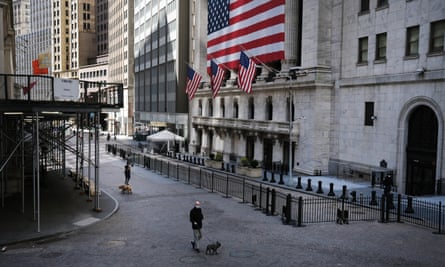 A person walks down Wall Street in New York. With a pandemic under way and a depression looming, the case for cancelling debt has taken on a new urgency.