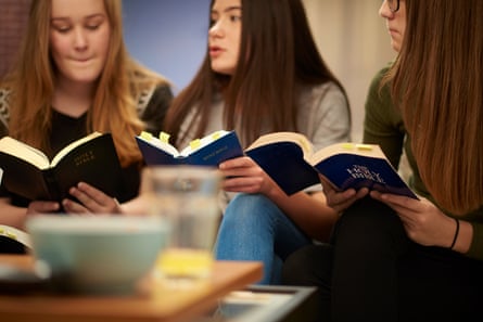 a group of three teenage girls sit at home and discuss the Bibles that they are reading