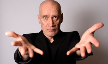 Wilko Johnson reaches out his hands toward the photographer