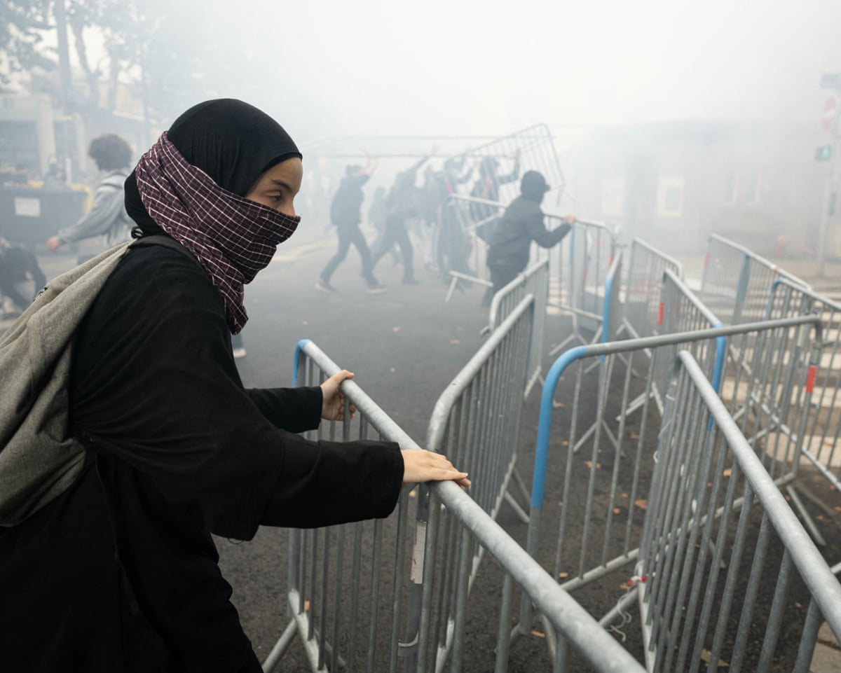 A student moves a barrier as students carry out a blocking protest at the Strasbourg University, in Strasbourg, eastern France.