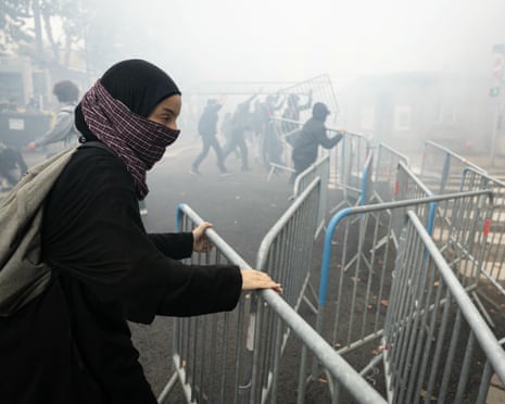A student moves a barrier as students carry out a blocking protest at the Strasbourg University, in Strasbourg, eastern France.