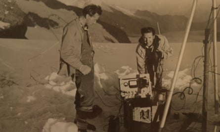 Donald Perkins, right, and Norman Barford sinking a pipe into the Aletsch glacier on the Jungfraujoch in the Bernese Alps in 1948, to test whether ice can be used to detect particles