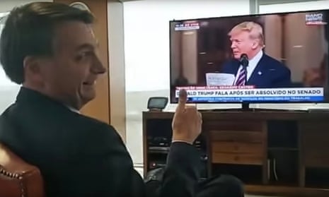 President Jair Bolsonaro gestures during a video of himself watching Donald Trump during his rambling post-impeachment speech.