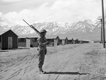 An American soldier guards a Japanese internment camp at Manzanar, California.