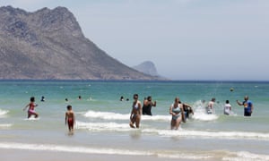 Swimmers enjoy a sweltering day at Strand Beach near Cape Town, South Africa, as new Covid-19 cases dropped in recent days.