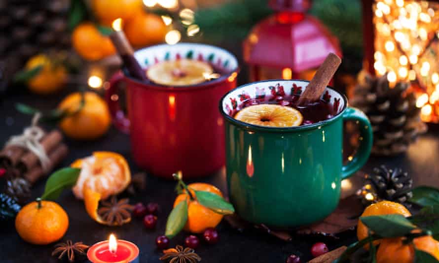 Mulled wine in rustic ceramic mugs on holiday Christmas background