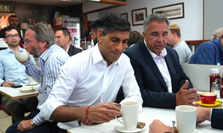 Rishi Sunak has a mug of tea with the newly elected Conservative MP Steve Tuckwell at a busy cafe in Uxbridge, west London, following the party’s success in the by-election.