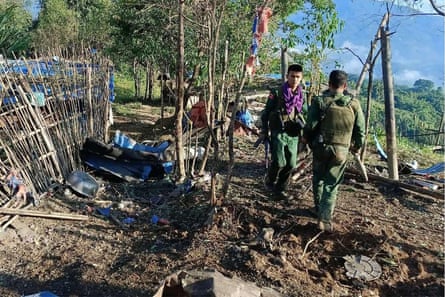 Members of the Myanmar National Democratic Alliance Army (MNDAA) walk past a Myanmar military base after seizing it during clashes near Laukkaing township in Myanmar’s northern Shan state in October 2023.