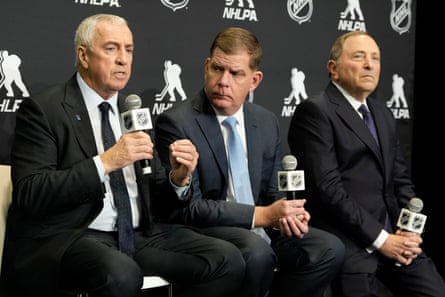 IIHF president Luc Tardif, left to right, NHLPA executive director Marty Walsh and NHL commissioner Gary Bettman speak at a news conference in Toronto on Friday.