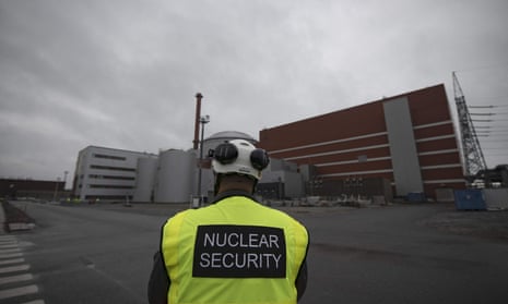 A security officer standing in front of the OL3, the third reactor of the nuclear power plant Olkiluoto, on the island of Eurajoki, western Finland. 