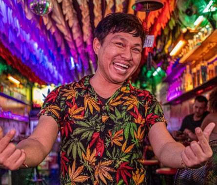 A Thai man dressed in a cannabis shirt poses for the camera