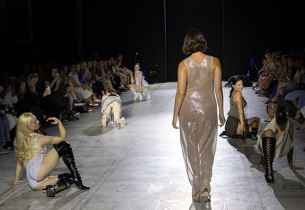 Models on the catwalk in slinky, revealing outfits and posing on the floor