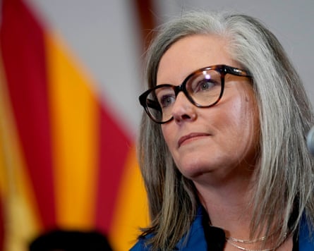 Woman with glasses looks off to the side
