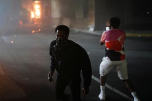 A man films a burning Wendy’s following a rally against racial inequality and the police shooting death of Rayshard Brooks, in Atlanta.