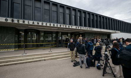 Journalists and spectators wait in front of a courthouse