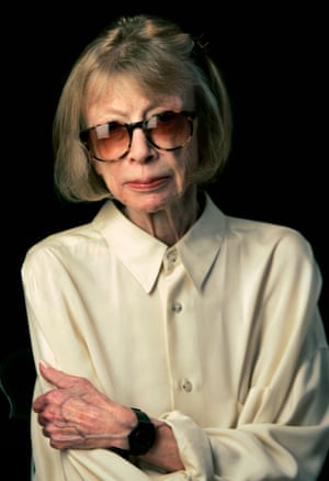 Didion wears a white shirt and dramatic glasses in this 2007 portrait against a black background.
