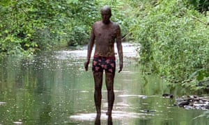 Antony Gormley statue wearing pants in the Water of Leith.