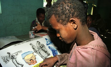 Ethiopian child pasting pictures